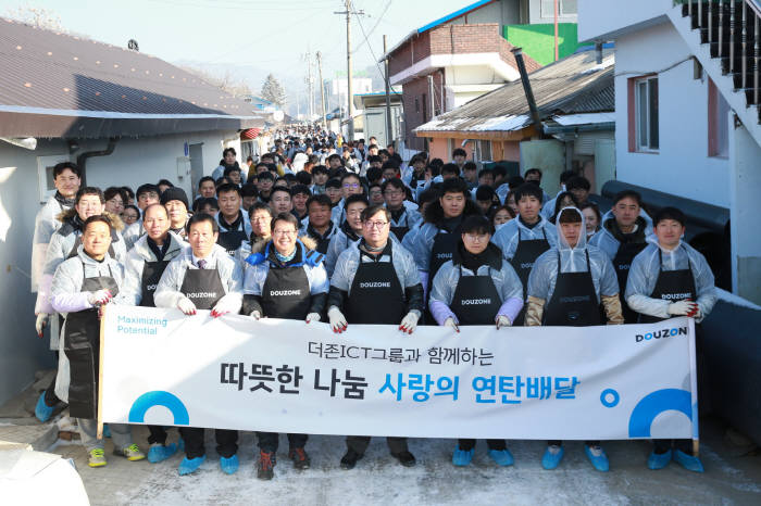 12일 춘천 더존ICT그룹 강촌캠퍼스 인근지역에 연탄배달 봉사에 나선 더존비즈온과 계열사 임직원들이 사진촬영을 하고 있다. 더존비즈온 제공